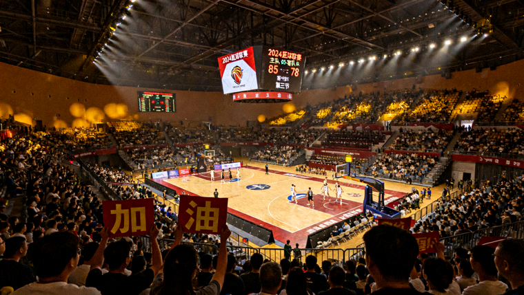 体育馆内实时比分显示屏与比赛现场观众席画面